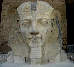 An impressive stone head of Ramses II is mounted on a plinth.