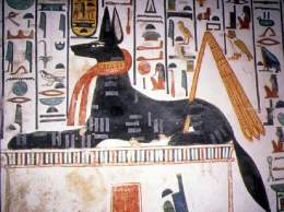 Anubis is stretched out on a tomb waiting to greet Nefertari.